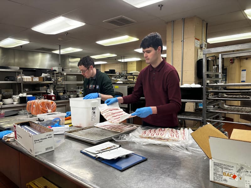 PAAL students Will and Jack preparing food in a commercial kitchen — vocational training in action