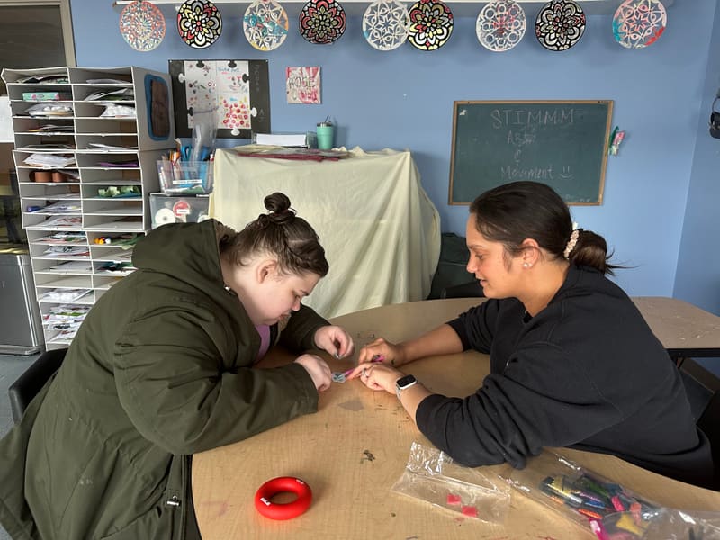 BCBA working one-on-one with a PAAL student on individualized programming
